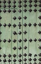 Door with decorative iron spikes