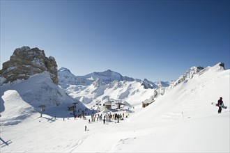 Skiers and snow-covered mountains