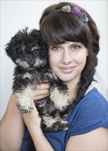 Young woman holding a Toy Poodle