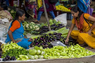 A woman is selling aubergines