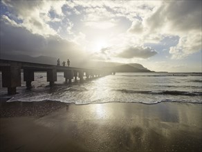 Family walking on a pier