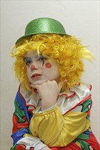 Little boy dressed as a clown