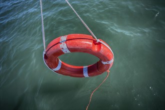 Lifebuoy dangling over water