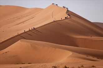 Tourists climbing the Sossusvlei Dunes