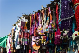Colourful clothes and bags for sale at the weekly flea market
