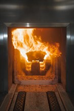 A coffin is cremated in the incinerator in a crematorium