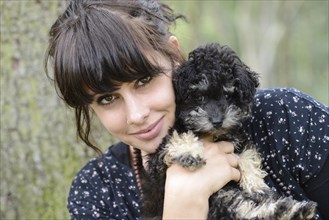 Young woman holding a Toy Poodle or Teacup Poodle