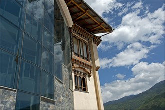 Modern glass facade and traditional-style windows at the headquarters of the Royal University of Bhutan