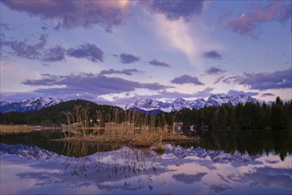 Geroldsee Lake with a reed island and the Karwendel Range at dusk
