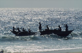 Fishermen departing the beach in a boat