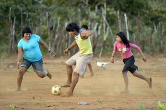 Youngers of the indigenous Xavante people playing football