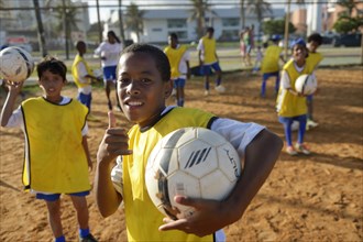 Brazilian boy with soccer ball in a social project of the Deutsche Gesellschaft fur Internationale Zusammenarbeit