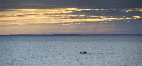 Fishing boat on the Curonian Lagoon at sunrise