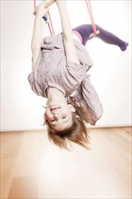 Girl exercising on a swing