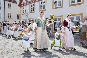 Women and children during a parade through the historic town centre