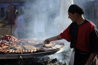 Cook handles giant barbecue at the annual All Saints Market in Cocentaina