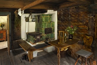 Living room with a tiled stove in Markus Wasmeier Farm and Winter Sports Museum