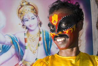 An artist with the complete make up of the character Garuda for the procession during a temple festival