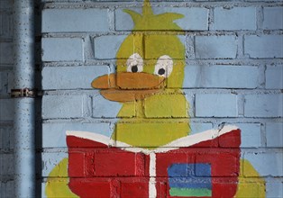 Duck figure reading a book