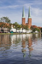 Cathedral reflected in Stadttrave river or Trave River