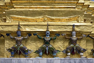 Guardian figures on a golden chedi