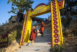 Buddhist novices with begging bowls at their morning begging tour