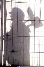 Shadow of a construction worker on a concrete wall