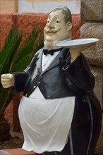 Figure in front of a restaurant