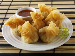 Dim sum with a chilli dipping sauce
