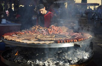 Cook handles giant barbecue at the annual All Saints Market in Cocentaina