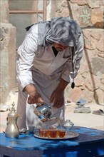 Modern Bedouin man preparing tea