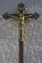 Carved wooden crucifix on the shingle facade of the parish church of St. Margaret