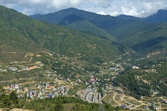 Construction of a new residential neighborhood on the outskirts of Thimphu as a result of rapid urbanization