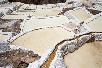 Salt pans with water course on a mountainside