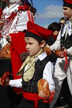 Boy in traditional costume taking part in a parade