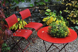 Red garden chairs and a table