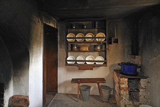 Kitchen of a farmhouse with soot-blackened walls
