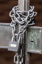 Chain with padlock on an iron gate