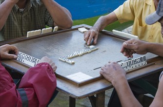 Four men playing dominoes