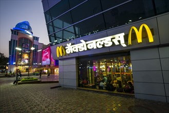 A McDonalds restaurant in a new and colorfully illuminated shopping mall
