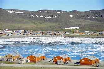 The Inuit village of Ulukhaktok with ice floes in the Beaufort Sea