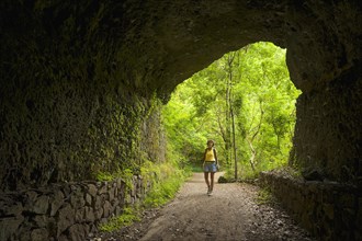 Hiker in a rock tunnel