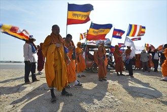 Cambodian monks and novices at a protest with Buddhist flags and national flags of Cambodia