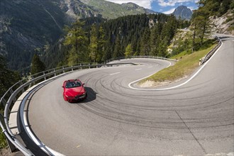 Red convertible travelling on the Maloja Pass