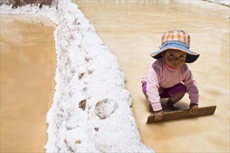 Child playing with a wooden board