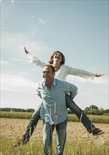 Man giving a woman a piggyback ride