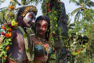 Shiva and Parvati sculptures displayed at a procession during a temple festival