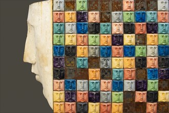 Skulpture made of tiles depicting faces