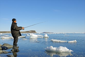 Man of the Inuit people fishing on the banks of the Beaufort Sea