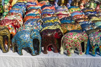 Colourful papier mache elephants for sale at the weekly flea market